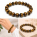 10 mm Tiger's Eye Bracelet with Gold Stainless Steel Cross Bead 10 mm Tiger's Eye Bracelet with Gold Stainless Steel Cross Bead