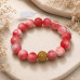 12 mm Strawberry Quartz Bracelet with Gold Stainless Steel Round Charm 12 mm Strawberry Quartz Bracelet with Gold Stainless Steel Round Charm