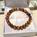 8 mm Tiger’s Eye Bracelet with Stainless Steel Charm 8 mm Tiger’s Eye Bracelet with Stainless Steel Charm