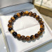 8 mm Tiger’s Eye Bracelet with Gold Stainless Steel Charm 8 mm Tiger’s Eye Bracelet with Gold Stainless Steel Charm