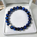 8 mm Dark Blue Tiger’s Eye Bracelet with Silver-Tone Stainless Steel Charm 8 mm Dark Blue Tiger’s Eye Bracelet with Silver-Tone Stainless Steel Charm