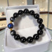 12 mm Black Obsidian Bracelet with Dark Grey Cat’s Eye and Murano-Style Crystal 12 mm Black Obsidian Bracelet with Dark Grey Cat’s Eye and Murano-Style Crystal