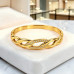 Gold-Tone Stainless Steel Bangle with Zirconia – Elegant Intertwined Design